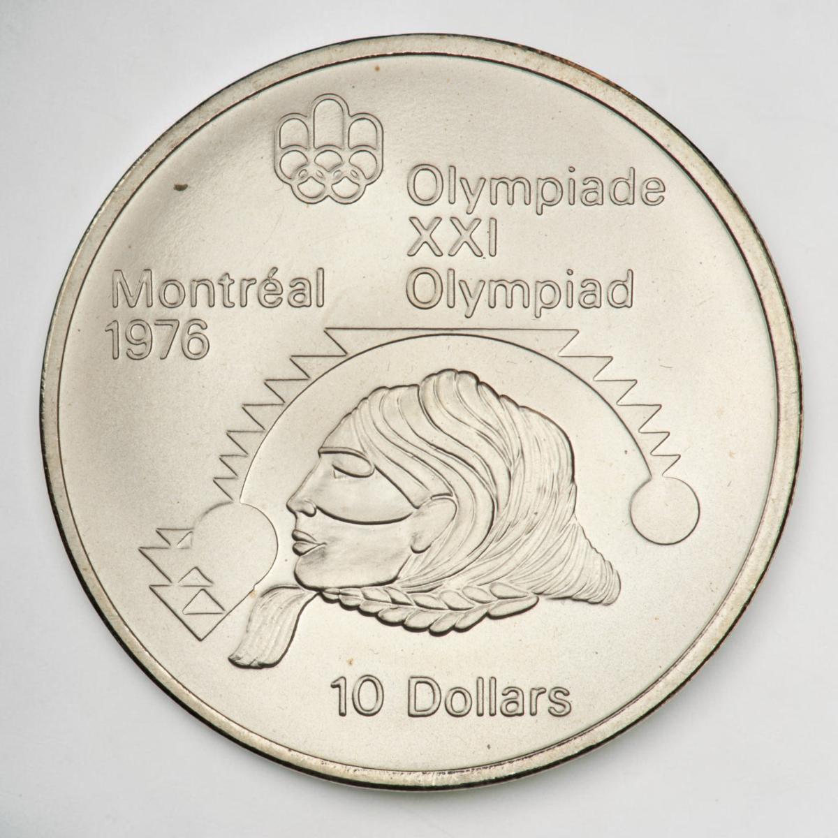 Pièce d’argent montrant de profil la tête d’une personne autochtone surmontée de symboles en zigzag avec des cercles de chaque côté.