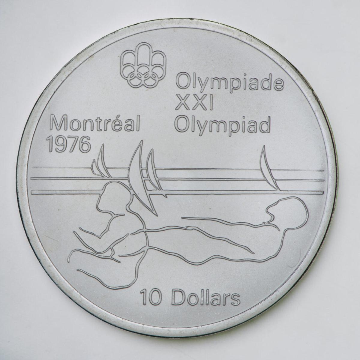 Pièce d’argent, silhouette stylisée de deux athlètes se penchant vers l’arrière pour stabiliser un voilier invisible.