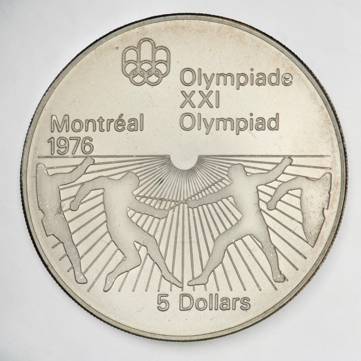 Pièce d’argent montrant des rayons de soleil sur la moitié inférieure et les silhouettes de deux personnes croisant le fer comme des escrimeurs.