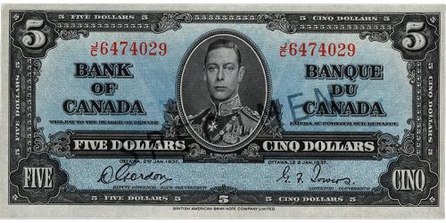 Billet de banque bleu, motifs géométriques complexes, jeune homme en uniforme militaire d’époque : le roi George VI.