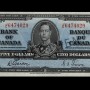 Billet de banque bleu, motifs géométriques complexes, jeune homme en uniforme militaire d’époque : le roi George VI.