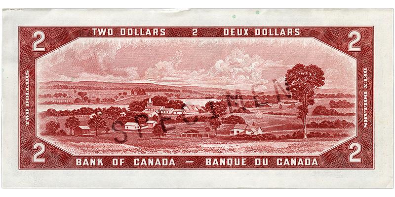 Billet de banque rouge brique, cadre constitué de motifs géométriques, fermes et village au bord d’une rivière, grand arbre à la droite du paysage.