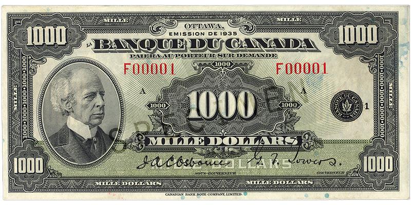 Billet de banque vert pâle, motifs géométriques complexes, homme chauve portant un habit à col montant d’époque : sir Wilfrid Laurier.