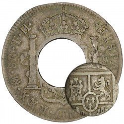 Pièce de monnaie ronde en argent trouée au milieu et petite pièce de la taille du trou.