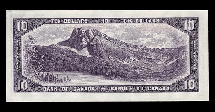 Billet de banque violet orné d’une grande gravure de montagne s’élevant derrière un lac et une forêt.