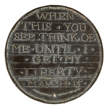 Pièce de cuivre polie, avec des mots gravés.  